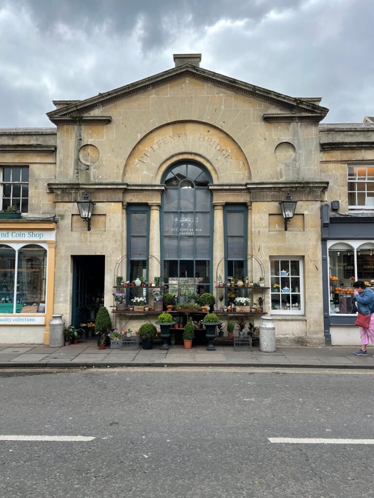 the storefront of Pulteney Bridge Flowers located on the historic Pulteney Bridge in Bath, England